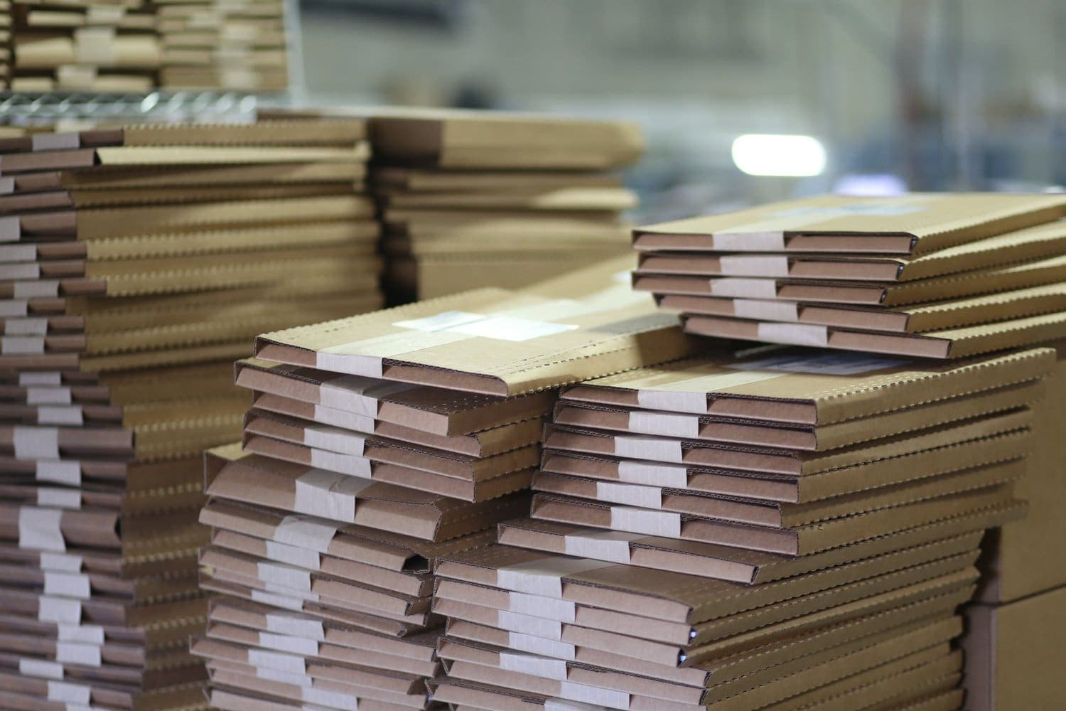 Stacks of books packed in cardboard mailers