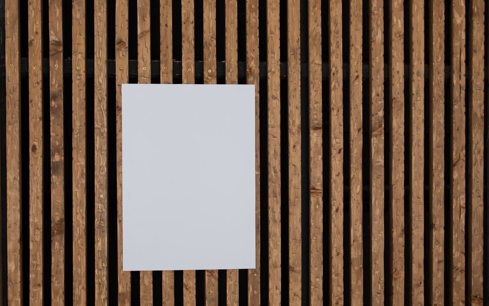 A poster hung on a slatted wood wall